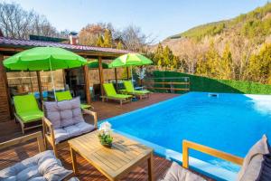 a patio with a table and chairs next to a swimming pool at Green View 2 in Skrino