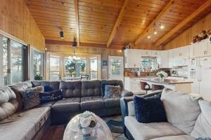 a living room with a couch and a table at Lakeside Serenity in Crestline +29 photos