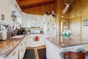 a kitchen with white cabinets and a counter top at Lakeside Serenity in Crestline