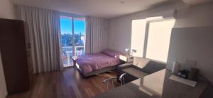 a room with a bed and a window with a view at La Raquel in La Plata