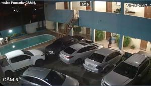 a group of cars parked in front of a building at Paulos Pousada in Lagoa Santa