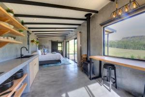 a room with a bed and a large window at Giantscup Wilderness Reserve in Underberg