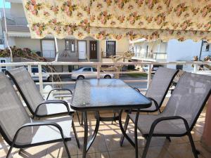 a table and four chairs on a patio at Johanna's apartment 2 in Preveza