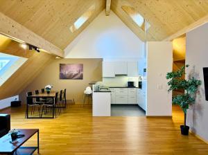 an attic kitchen and dining room with a dining table at TONIGHT Apartments in Bottmingen