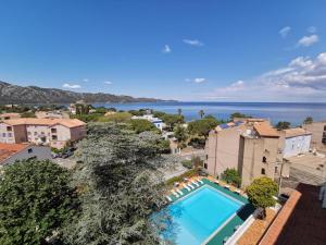 an overhead view of a swimming pool and the ocean at Hotel Madame Mere in Saint-Florent