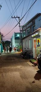 a group of animals walking down a street near a building at Beach Times Resort in Kottakupam
