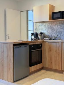 a kitchen with a sink and a dishwasher at Les Suites Villeneuve - 2 in Le Puy-en-Velay