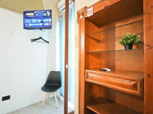 a wooden door with a chair in a room at Azzurro A Mare in Polignano a Mare