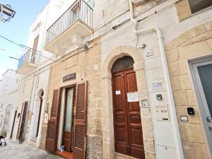 a building with wooden doors on a street at Azzurro A Mare in Polignano a Mare +54 photos