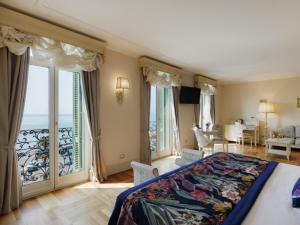 a bedroom with a large bed with a view of the ocean at Hotel De Paris Sanremo in Sanremo +76 photos