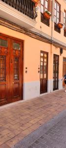 a building with wooden doors on a street at Las Arenas Suites 1 PLAYA in Valencia