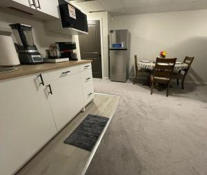 a kitchen with a counter and a table with chairs at Mary's Luxury Suite in Winnipeg +23 photos