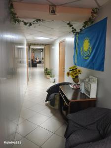 a room with a flag on the wall and a table at Rassvet in Lenīnogorsk