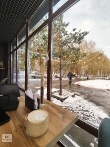a room with a large window looking out at a street at Rassvet in Lenīnogorsk