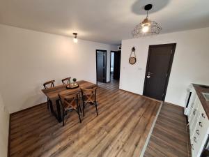 a kitchen and dining room with a table and chairs at Апартамент Бохо 2 in Primorsko +5 photos
