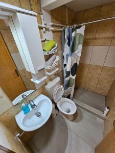 a small bathroom with a toilet and a sink at Lira Apartmani in Prnjavor