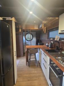 a kitchen with a wooden counter top and a table at La Perle des Sentiers in Rhisnes +23 photos