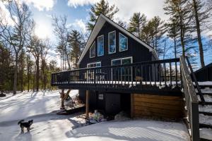 a black house with a deck in the snow at Private Fire Pit Pool Table Barry Manor in Barryville