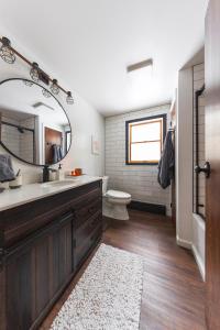 a bathroom with a sink and a toilet and a mirror at Private Fire Pit Pool Table Barry Manor in Barryville +35 photos