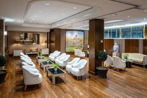 a waiting room with white chairs and tables at Agumar Atocha in Madrid