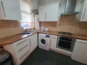 a kitchen with a sink and a washing machine at Blyth 1 Bedroom Apartment in Blythe