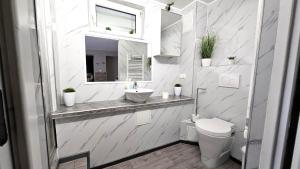 a white bathroom with a sink and a toilet at Flatprovider - Manuela Apartment Vienna in Vienna +27 photos