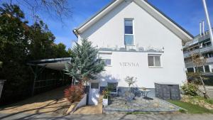 a white house with a christmas tree in front of it at Flatprovider - Manuela Apartment Vienna in Vienna