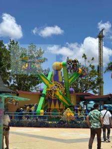 a carnival ride with a roller coaster at Charm Condo Just Steps from Enchanted Kingdom Sargas in Santa Rosa