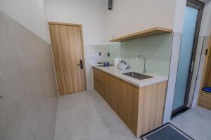 a small kitchen with a sink and a door at An Thy HOTEL in Vung Tau +8 photos