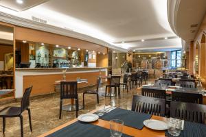 a restaurant with tables and chairs and a bar at Agumar Atocha in Madrid