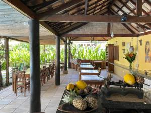 a patio with tables and chairs and fruit on a table at Atobá Villas in Paraty