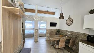 a kitchen and dining room with a table and a clock at Flatprovider - Manuela Apartment Vienna in Vienna