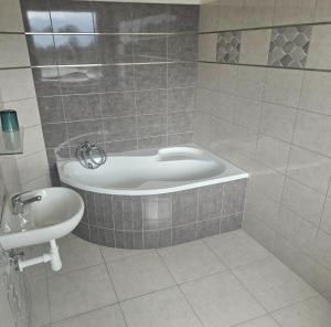 a bathroom with a bath tub and a sink at Vlčí důl Bludov in Bludov +20 photos