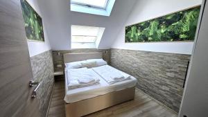 a small bedroom with a bed and a window at Flatprovider - Manuela Apartment Vienna in Vienna