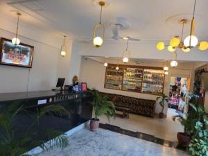 a lobby of a restaurant with potted plants at Hotel Maha Luxmi Palace in Katra