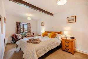 a bedroom with a large bed and a couch at 2 Bed in Clitheroe oc-la156 in Harrop Fold