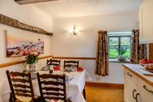 a dining room with a table and a kitchen at 2 Bed in Clitheroe oc-la156 in Harrop Fold