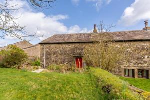 an old stone house with a red door at 2 Bed in Clitheroe oc-la156 in Harrop Fold +8 photos