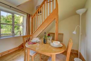 a dining room with a table and a staircase at 1 Bed in Bergh Apton oc-1387 in Thurton +4 photos