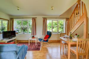 a living room with a blue couch and a table at 1 Bed in Bergh Apton oc-1387 in Thurton