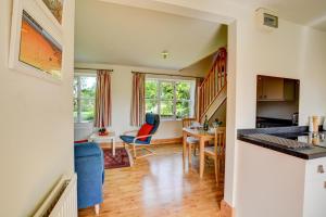 a kitchen and living room with a table and chairs at 1 Bed in Bergh Apton oc-1387 in Thurton