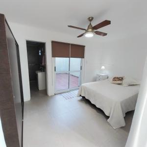 a bedroom with a bed and a ceiling fan at La Ñata Apart in Junín