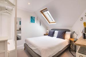 a bedroom with a bed and a window at 2 Bed in Looe oc-l30069 in Looe