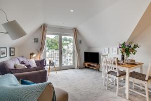 a living room with a couch and a table at 2 Bed in Looe oc-l30069 in Looe