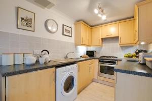 a kitchen with a washing machine and a sink at 2 Bed in Looe oc-l30069 in Looe +2 photos