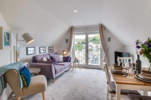 a living room with a couch and a table at 2 Bed in Looe oc-l30069 in Looe