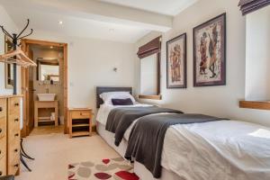 a bedroom with two beds and a mirror at 4 Bed in Thwing oc-t29013 in Thwing +22 photos