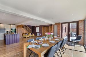 a dining room and living room with a table and chairs at 4 Bed in Thwing oc-t29013 in Thwing