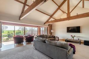 a living room with a couch and a tv at 4 Bed in Thwing oc-t29013 in Thwing