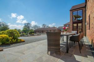 an outdoor patio with a table and chairs at 4 Bed in Thwing oc-t29013 in Thwing